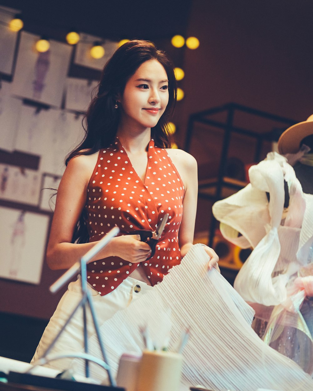 Fabric being cut by hand on the atelier table