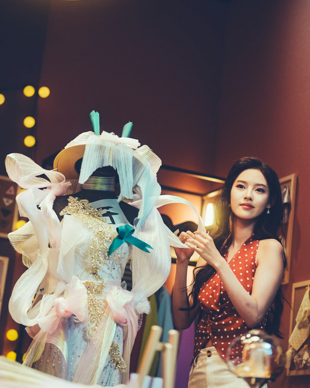 A gown being finished on a dress form
