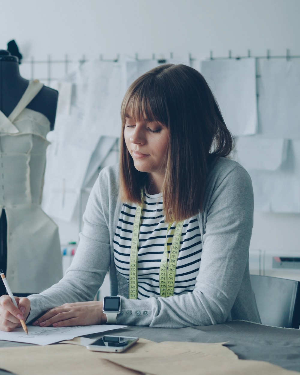 Sketches and fabric being reviewed in the Saint Therese atelier